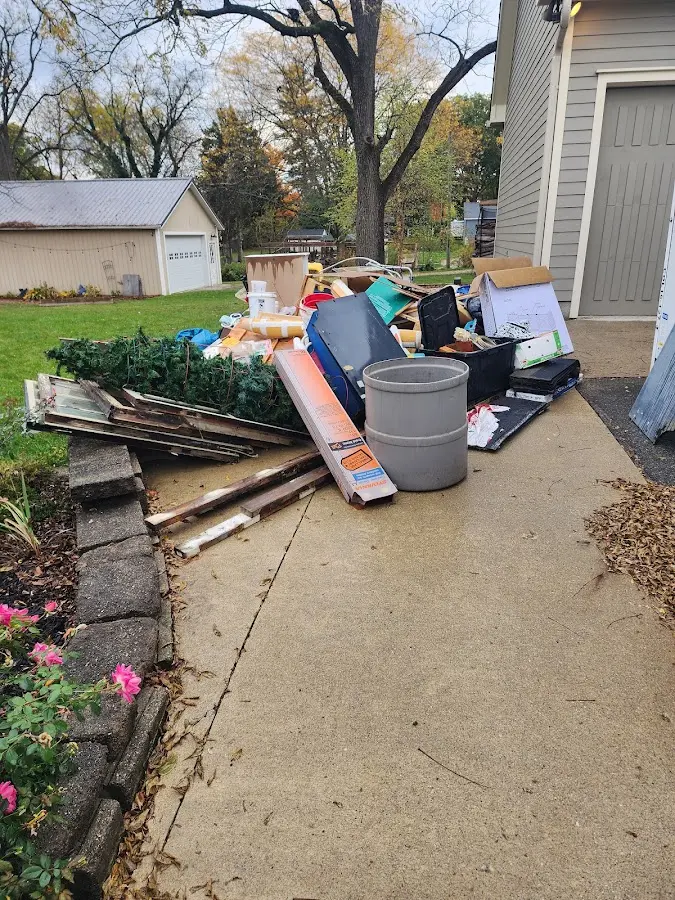 Dumpster being loaded with debris for Estate Cleanout Dumpster Rental in Doolittle